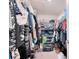 Well-organized walk-in closet with ample shelving, hanging space, and lots of personal items at 454 Hamlet Loop, Davenport, FL 33837