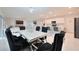 Elegant dining area with stylish black chairs, a marble table, and a modern chandelier at 454 Hamlet Loop, Davenport, FL 33837