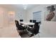 Formal dining room boasts a marble-top table, plush seating, and designer lighting at 454 Hamlet Loop, Davenport, FL 33837
