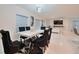 Elegant dining room features a modern chandelier, wall art and marble table with luxurious seating at 454 Hamlet Loop, Davenport, FL 33837