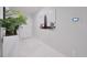 Modern entryway with greenery, striking airplane art, and sleek marble tile floors at 454 Hamlet Loop, Davenport, FL 33837