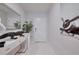 Modern entryway with white console, artistic mirror, striking airplane art, and sleek marble tile floors at 454 Hamlet Loop, Davenport, FL 33837