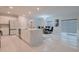 Bright, open-concept kitchen featuring a large island with quartz countertops and stainless steel appliances at 454 Hamlet Loop, Davenport, FL 33837