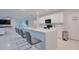 Open kitchen with a large quartz island and counter seating, complemented by sleek, modern appliances at 454 Hamlet Loop, Davenport, FL 33837
