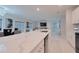 Bright, open kitchen featuring a quartz island, modern appliances, and views into the living space at 454 Hamlet Loop, Davenport, FL 33837