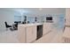 Spacious kitchen showcasing an expansive quartz island, modern cabinetry, and an open-concept design at 454 Hamlet Loop, Davenport, FL 33837