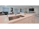 Bright kitchen featuring quartz countertops, a stainless steel sink, and modern fixtures, perfect for cooking at 454 Hamlet Loop, Davenport, FL 33837