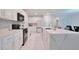 Bright kitchen featuring stainless steel appliances, quartz countertops, and modern design elements at 454 Hamlet Loop, Davenport, FL 33837