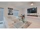 Bright living room featuring a white leather sectional sofa, modern fireplace, and mirrored coffee table at 454 Hamlet Loop, Davenport, FL 33837
