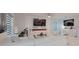 Stylish living room boasts modern decor, white furniture, sleek fireplace, and elegant accents at 454 Hamlet Loop, Davenport, FL 33837