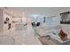 Open-concept living space with a modern kitchen, dining area, and cozy seating area with stylish decor at 454 Hamlet Loop, Davenport, FL 33837