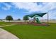 Well-maintained playground area with a shade structure, slide, and swing set at 454 Hamlet Loop, Davenport, FL 33837