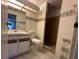 Well-lit bathroom featuring a classic vanity, a toilet, and a shower at 4905 Sanoma Vlg # Ge, Orlando, FL 32808