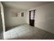 Spacious bedroom with tiled floors and a window with curtains at 4905 Sanoma Vlg # Ge, Orlando, FL 32808