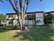 Two-story apartment with lawn area, mature tree, and a wooden balcony at 4905 Sanoma Vlg # Ge, Orlando, FL 32808