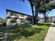 Spacious lawn area, mature tree and wooden balconies for this two-story apartment at 4905 Sanoma Vlg # Ge, Orlando, FL 32808