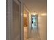 Bright hallway leading to a kitchen and bathroom with tile floors at 4905 Sanoma Vlg # Ge, Orlando, FL 32808