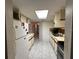 Galley style kitchen with white appliances, tile floors, and ample counter space at 4905 Sanoma Vlg # Ge, Orlando, FL 32808