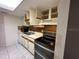 Traditional style kitchen features tile floors, white appliances, and ample storage at 4905 Sanoma Vlg # Ge, Orlando, FL 32808