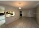 Open-concept living area with tile floors, dining space, and a view into the kitchen at 4905 Sanoma Vlg # Ge, Orlando, FL 32808