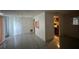 Open living area features neutral paint, tile floors, and view into kitchen at 4905 Sanoma Vlg # Ge, Orlando, FL 32808