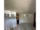 Open living room with tile flooring, natural light, and view into kitchen at 4905 Sanoma Vlg # Ge, Orlando, FL 32808