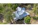Birds-eye view of home featuring new metal roof, dormer windows, and manicured lawn at 525 W Blue Springs Ave, Orange City, FL 32763