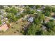 Aerial view of a large property featuring a spacious home, detached garage, and mature landscaping at 525 W Blue Springs Ave, Orange City, FL 32763
