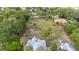 Aerial view of the property showcasing a large lot, mature trees, and well-maintained home at 525 W Blue Springs Ave, Orange City, FL 32763
