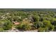 Wide aerial shot showcases the property with large acreage, detached garage, and street view at 525 W Blue Springs Ave, Orange City, FL 32763