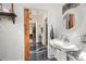 Bright bathroom featuring a pedestal sink, patterned floors, and vintage-style fixtures at 525 W Blue Springs Ave, Orange City, FL 32763