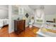 Bathroom with a pedestal sink, soaking tub, and a view outside at 525 W Blue Springs Ave, Orange City, FL 32763