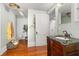 Bathroom featuring vintage fixtures, hardwood floors, and decorative accents at 525 W Blue Springs Ave, Orange City, FL 32763
