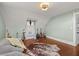 Charming bedroom with hardwood floors, musical instruments, and a cowhide rug at 525 W Blue Springs Ave, Orange City, FL 32763