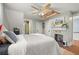 Bedroom features a ceiling fan, fireplace, and unique architectural details at 525 W Blue Springs Ave, Orange City, FL 32763