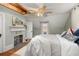 Bedroom with exposed ceiling beams, fireplace, and view into adjacent rooms at 525 W Blue Springs Ave, Orange City, FL 32763