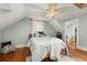 Bedroom with hardwood floors, wooden bed frame, and decorative pillows at 525 W Blue Springs Ave, Orange City, FL 32763