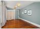 Stylish bedroom with hardwood floors, accent wall, and unique decor, offering a comfortable and personalized space at 525 W Blue Springs Ave, Orange City, FL 32763