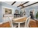 Open dining room with hardwood floors, wooden table, and stylish lighting fixtures at 525 W Blue Springs Ave, Orange City, FL 32763