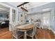 Bright dining room with hardwood floors, a wooden table, and views into the living room at 525 W Blue Springs Ave, Orange City, FL 32763