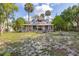 Inviting two-story home with a wrap-around porch and meticulously manicured landscaping at 525 W Blue Springs Ave, Orange City, FL 32763