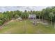A classic two-story home is situated on a generous lot with mature trees and plenty of space for outdoor activities at 525 W Blue Springs Ave, Orange City, FL 32763
