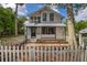 Charming two-story home with a white picket fence, and well-manicured landscaping at 525 W Blue Springs Ave, Orange City, FL 32763