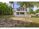 Quaint two-story home with a white picket fence, and mature trees at 525 W Blue Springs Ave, Orange City, FL 32763