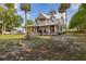 Aesthetic two-story home with large wrap around porch, front fountain, and an oversized lot at 525 W Blue Springs Ave, Orange City, FL 32763