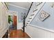 Entryway with staircase, decorative wall art, and view into a bathroom with sliding barn door at 525 W Blue Springs Ave, Orange City, FL 32763