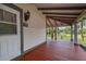 Inviting front porch offering views of lush greenery and natural beauty at 525 W Blue Springs Ave, Orange City, FL 32763