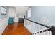 Bright hallway with wood floors, light blue walls, and decorative accents at 525 W Blue Springs Ave, Orange City, FL 32763