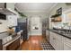 Well-lit kitchen featuring stainless steel appliances, hardwood floors, and classic cabinetry at 525 W Blue Springs Ave, Orange City, FL 32763