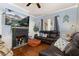 Inviting living room featuring a fireplace, hardwood floors, and comfortable leather seating at 525 W Blue Springs Ave, Orange City, FL 32763